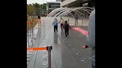 Kids racing under a water archway